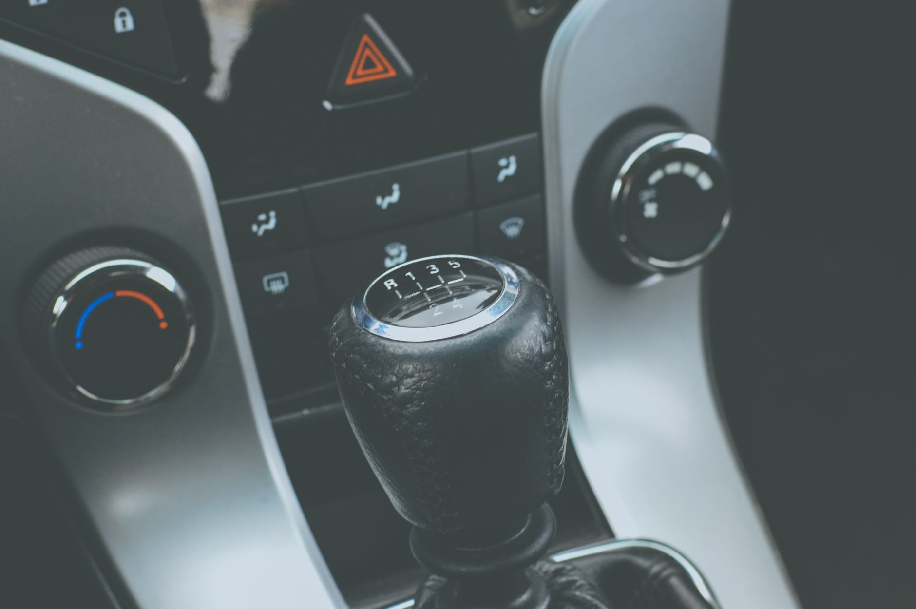 A manual gear stick and the surrounding console, the small piece of the car that humbles every new driver
