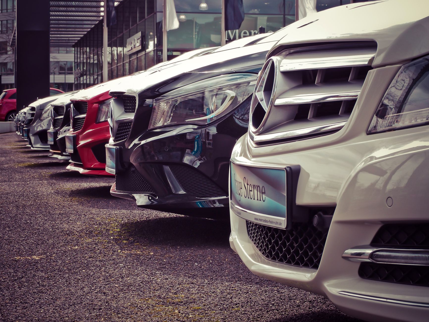 A row of second-hand cars lined up for sale, where a calm head saves more money than a good haggle